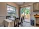 Bright dining area features sliding glass doors to a private fenced yard with mature trees at 999 Osceola St, Denver, CO 80204