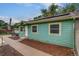 View of the home's exterior, featuring a light blue paint job, mulch bed, and well-maintained walkway at 999 Osceola St, Denver, CO 80204