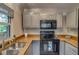 Functional kitchen features updated cabinets, black appliances, and ample counter space at 999 Osceola St, Denver, CO 80204