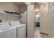 Laundry area with stacked washer and dryer and access to full bathroom at 999 Osceola St, Denver, CO 80204