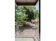 This balcony with a metal railing overlooks neighboring street with lush greenery at 1 N Pearl St # 201, Denver, CO 80203