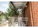 Balcony featuring a metal railing, outdoor lights, and brick exterior wall at 1 N Pearl St # 201, Denver, CO 80203