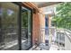 This condo balcony has a metal railing and overlooks neighboring homes at 1 N Pearl St # 201, Denver, CO 80203