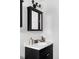 Elegant bathroom features a black vanity cabinet with a white sink and modern faucet at 1 N Pearl St # 201, Denver, CO 80203