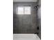 The updated bathroom features tile surround, a shower head, and a tub at 1 N Pearl St # 201, Denver, CO 80203