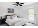 Bright bedroom with a ceiling fan, walk-out access to balcony, and natural light at 1 N Pearl St # 201, Denver, CO 80203