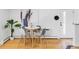 Modern dining area with a white table, seating for four, light wood flooring, and minimalist decor at 1 N Pearl St # 201, Denver, CO 80203
