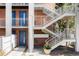 Brick apartment building exterior featuring blue doors, white railings, and staircase, providing a bright and modern look at 1 N Pearl St # 201, Denver, CO 80203