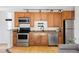 Charming kitchen with stainless steel appliances, wooden cabinets, and granite countertops, offering modern convenience at 1 N Pearl St # 201, Denver, CO 80203