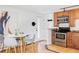 A cozy kitchen featuring wood cabinets, stainless steel appliances, granite countertops and adjacent dining area at 1 N Pearl St # 201, Denver, CO 80203
