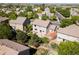 Aerial view of the house and backyard with patio, landscaping, and tree lined street at 11842 Altura St, Commerce City, CO 80603