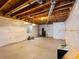 Unfinished basement featuring a concrete floor, exposed ceiling, and window at 11842 Altura St, Commerce City, CO 80603