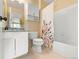 Well-maintained bathroom with modern sink and vanity and a bathtub with a floral shower curtain at 11842 Altura St, Commerce City, CO 80603