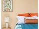 Close up of a well decorated bedroom with floral artwork above the bed and side table at 11842 Altura St, Commerce City, CO 80603
