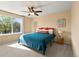 Cozy bedroom with a ceiling fan, large window and neutral tones provide a serene and relaxing atmosphere at 11842 Altura St, Commerce City, CO 80603