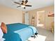 Comfortable bedroom featuring a ceiling fan, doorway to bathroom, and warm neutral decor at 11842 Altura St, Commerce City, CO 80603