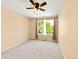 Bright bedroom featuring a ceiling fan, neutral carpet, and a large window bringing in natural light at 11842 Altura St, Commerce City, CO 80603