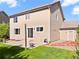 Back exterior view of home highlighting siding, windows, patio and walkway at 11842 Altura St, Commerce City, CO 80603