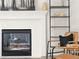 Close up of fireplace and mantel with tile surround, next to bookshelves at 11842 Altura St, Commerce City, CO 80603