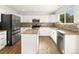 Spacious kitchen features white cabinets, a center island, and stainless steel appliances at 11842 Altura St, Commerce City, CO 80603