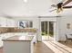 Bright kitchen featuring granite countertops, modern appliances, and an adjacent sunlit dining area at 11842 Altura St, Commerce City, CO 80603