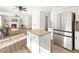 Open-concept kitchen featuring a center island and stainless-steel appliances at 11842 Altura St, Commerce City, CO 80603