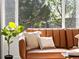Close up view of a leather couch with pillows, a side table, and house plant near window at 11842 Altura St, Commerce City, CO 80603