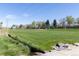 Lush green park with a playground, stream, and open fields perfect for outdoor activities at 1021 Carr St # 17, Lakewood, CO 80214