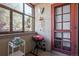 Cozy front patio with windchimes, grill and view through window at 1021 Carr St # 17, Lakewood, CO 80214