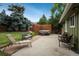 Inviting backyard patio with hot tub, seating, and mature trees creating a private outdoor oasis at 11805 W 74Th Ave, Arvada, CO 80005