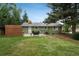 Backyard featuring a patio, dining set, and well-maintained lawn at 11805 W 74Th Ave, Arvada, CO 80005