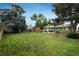 Expansive backyard featuring a lush lawn, mature trees, and wooden fence at 11805 W 74Th Ave, Arvada, CO 80005
