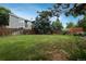 Spacious backyard with lush greenery and a secure wooden fence perimeter at 11805 W 74Th Ave, Arvada, CO 80005
