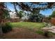 Tranquil backyard with a mature tree, lush lawn, and a wooden fence at 11805 W 74Th Ave, Arvada, CO 80005