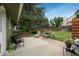 Lush backyard features patio, seating, and mature trees for a serene outdoor living space at 11805 W 74Th Ave, Arvada, CO 80005