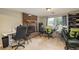 Multi-purpose basement area with a brick fireplace, sewing space, and natural lighting at 11805 W 74Th Ave, Arvada, CO 80005
