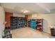 Organized basement storage area with ample shelving, good lighting, and neutral carpeting at 11805 W 74Th Ave, Arvada, CO 80005