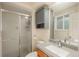 Well-lit bathroom with a shower, grey vanity cabinet, updated fixtures, and a functional design at 11805 W 74Th Ave, Arvada, CO 80005