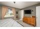 Cozy bedroom featuring neutral walls, plush carpeting, and a large window for natural light at 11805 W 74Th Ave, Arvada, CO 80005