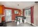 Stylish dining area with built-in seating, bright lighting, and easy access to backyard at 11805 W 74Th Ave, Arvada, CO 80005