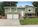 Home featuring solar panels, a charming entryway, and a well-maintained lawn at 11805 W 74Th Ave, Arvada, CO 80005