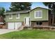 Home with brick accents, mature trees, a well-maintained lawn, and charming details at 11805 W 74Th Ave, Arvada, CO 80005