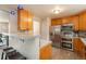 Kitchen showcases stainless steel appliances, breakfast bar with seating, wood cabinets and wood-look flooring at 11805 W 74Th Ave, Arvada, CO 80005