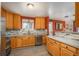 Kitchen showcases stainless steel appliances, stone countertops and wood cabinets with wood-look flooring at 11805 W 74Th Ave, Arvada, CO 80005