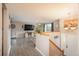 Bright living room with wood-look flooring, a large TV, and natural light at 11805 W 74Th Ave, Arvada, CO 80005