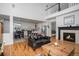 Living room with fireplace and view into the kitchen area at 4357 Ivycrest Pt, Highlands Ranch, CO 80130