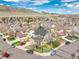 An aerial view of a neighborhood featuring a well-maintained home, mature trees and mountain views at 9407 W Gibraltar Pl, Littleton, CO 80127