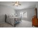 Cozy bedroom with neutral tones, a comfortable bed, a ceiling fan, and natural light from a window at 9407 W Gibraltar Pl, Littleton, CO 80127