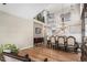 Elegant dining area with a grand chandelier, wood floors, staircase, and views of the upper level at 9407 W Gibraltar Pl, Littleton, CO 80127