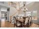 Stunning dining room featuring a large dining table, staircase, chandelier, and bright natural light at 9407 W Gibraltar Pl, Littleton, CO 80127